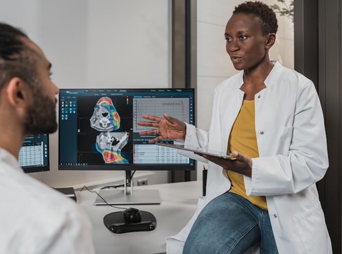 Clinicians reviewing medical imagery, where interpreter services protect patient safety