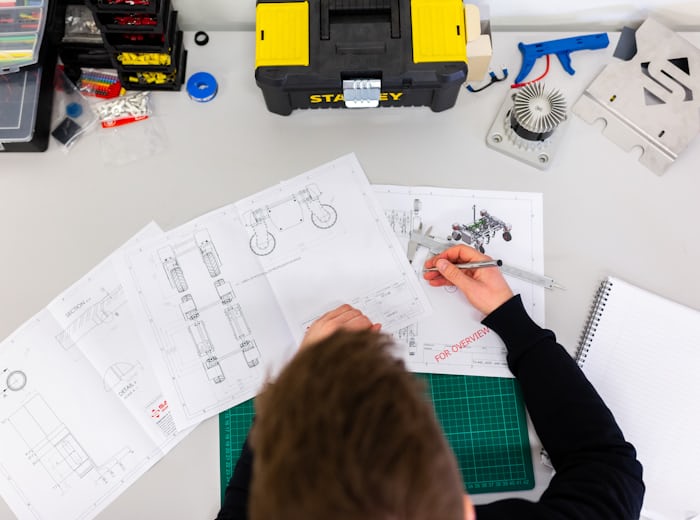 Engineer drafting technical drawings that require precise engineering translation