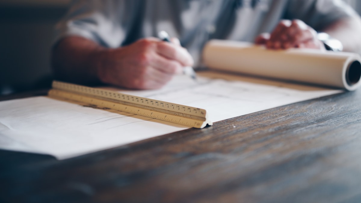 Engineer working over technical blueprint drawings