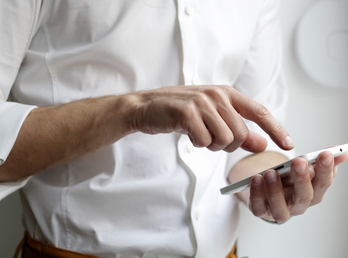 Person checking a website on a smartphone, where multilingual SEO drives discovery